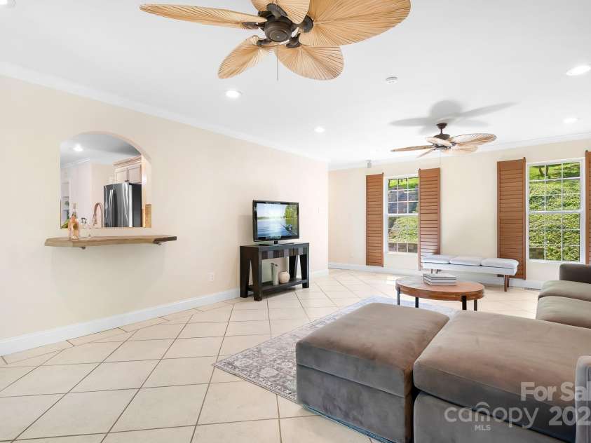 234 Winding Shore Road, Troutman, NC 28166.  MLS# CAR4245762, YatesRealty ID 10588. This bright, spacious great room, is connected to the kitchen by an arched window accented with a stone counter.