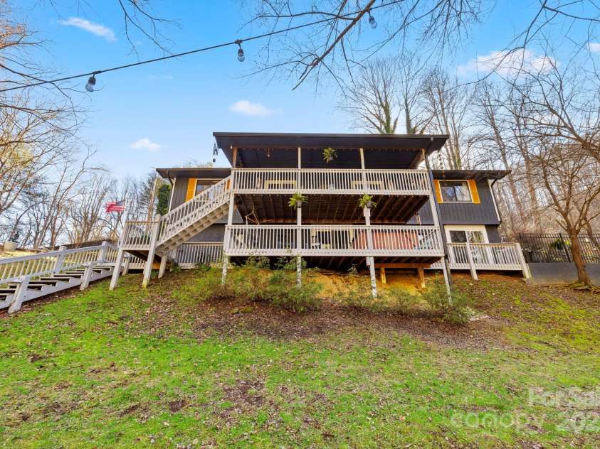 228 White Oak Road, Waynesville, NC 28785.  MLS# CAR4215162, YatesRealty ID 10603. Lots of porch space overlooking the creek