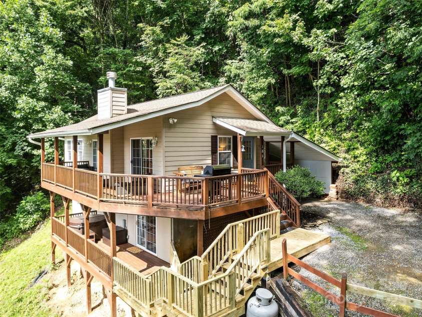 181 Rebel Ridge Road, Maggie Valley, NC 28751.  MLS# CAR4234696, YatesRealty ID 10625. Deck expansion in 2023 to access hot tub from multiple areas