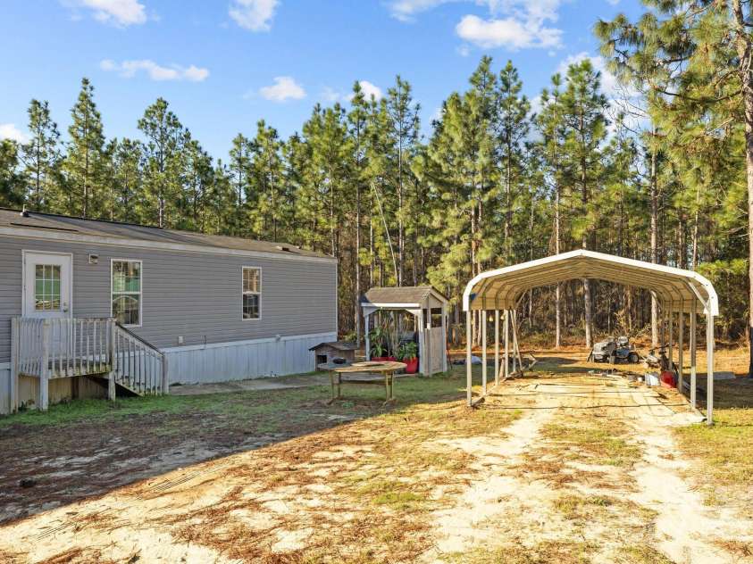 1266 Scott Road, Kershaw, SC 29067.  MLS# CAR4238168, YatesRealty ID 10635. Rear of Home w/Carport