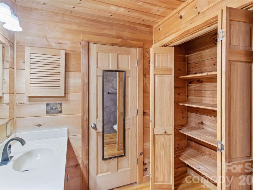 17 Aaron Way, Waynesville, NC 28786.  MLS# CAR4319469, YatesRealty ID 1067. Linen Closet in Primary Bathroom