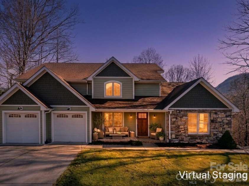98 Sovereign Lane, Fairview, NC 28730.  MLS# CAR4326130, YatesRealty ID 10689. Twilight exterior render with virtually staged area on spacious front porch