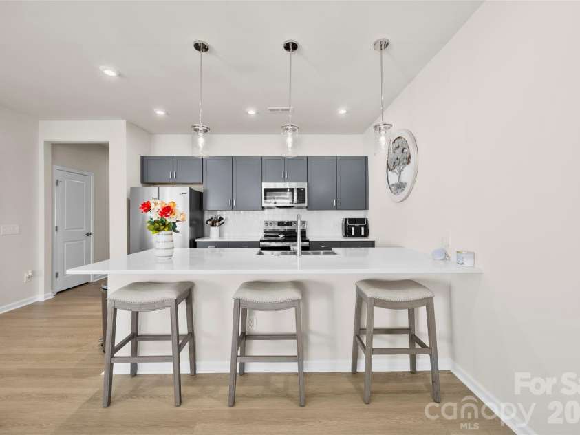 2312 Endeavor Run, Charlotte, NC 28269.  MLS# CAR4365921, YatesRealty ID 10692. Kitchen with bar stools 
