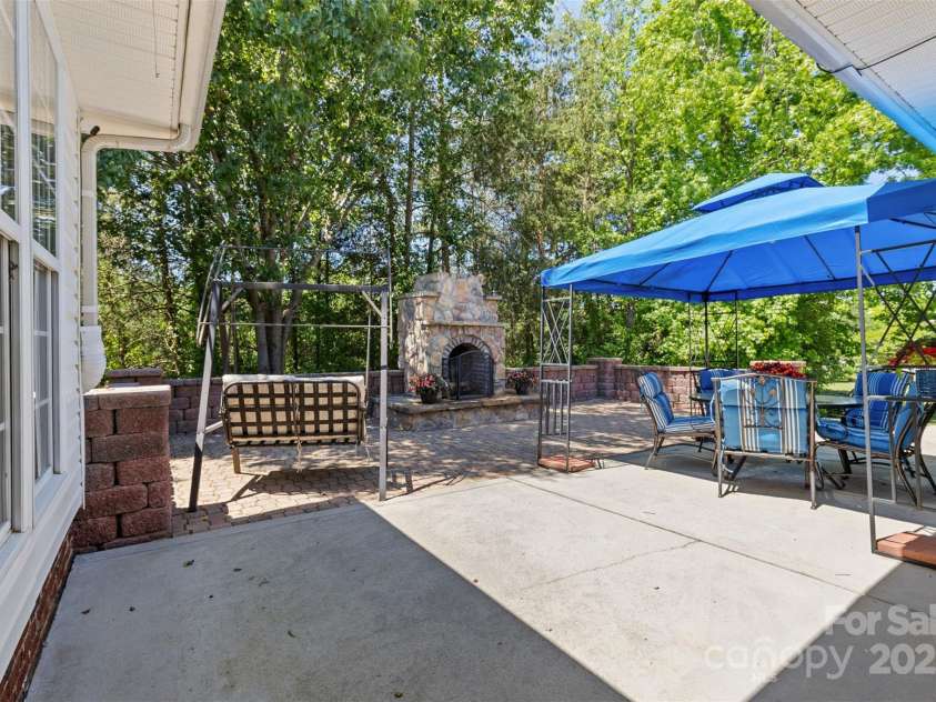 3744 Leela Palace Way, Fort Mill, SC 29708.  MLS# CAR4252438, YatesRealty ID 10708. Patio with  stone Fireplace