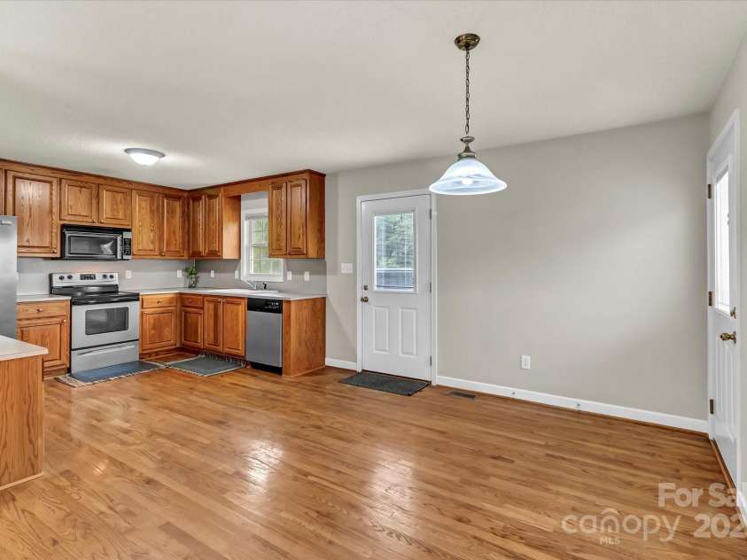 4773 Westwinds Road, Lincolnton, NC 28092.  MLS# CAR4243284, YatesRealty ID 10710. Kitchen flows into dining area—classic oak cabinetry throughout