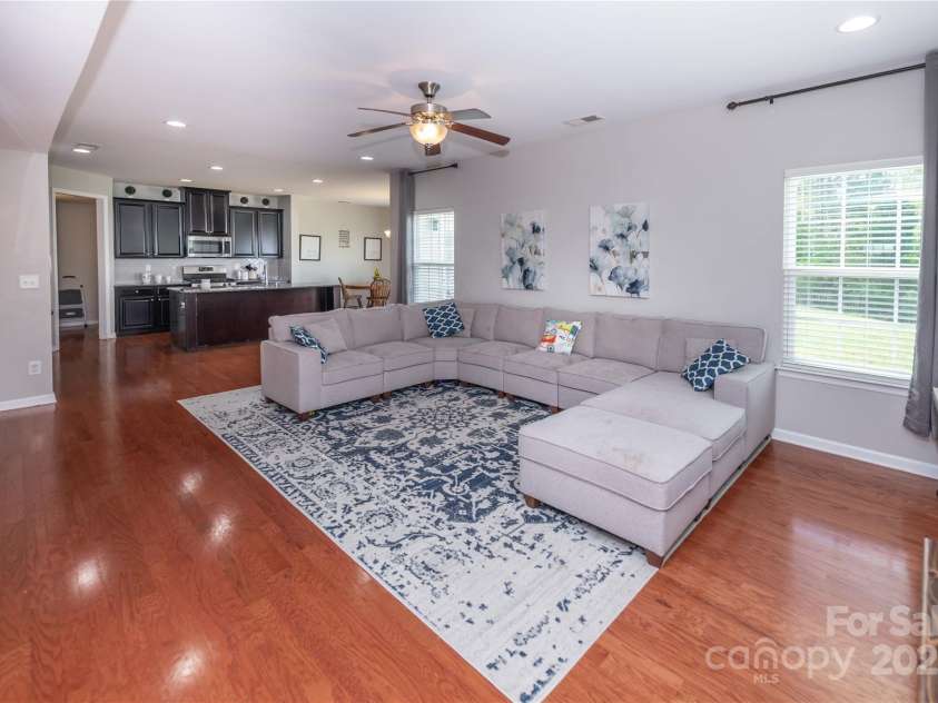 7412 Greene Mill Avenue, Concord, NC 28025.  MLS# CAR4249641, YatesRealty ID 10718. Huge living room with wood floors and ample lighting