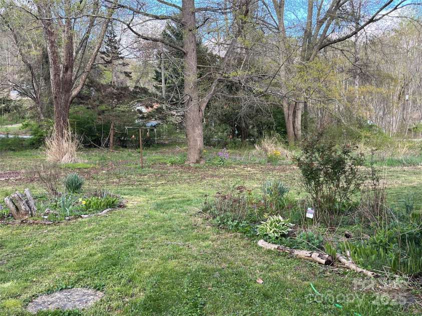 382 Starnes Cove Road, Candler, NC 28715.  MLS# CAR4246519, YatesRealty ID 10721. Back yard