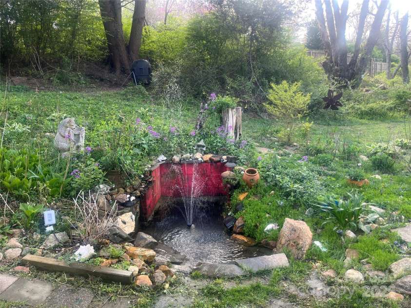 382 Starnes Cove Road, Candler, NC 28715.  MLS# CAR4246519, YatesRealty ID 10721. Spring w/ water feature