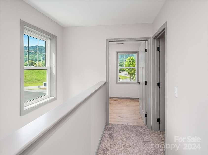 200 Red Twig Lane, Burnsville, NC 28714.  MLS# CAR4167529, YatesRealty ID 10723. Hallway between back of home guest Bedrooms and Primary on Upper level