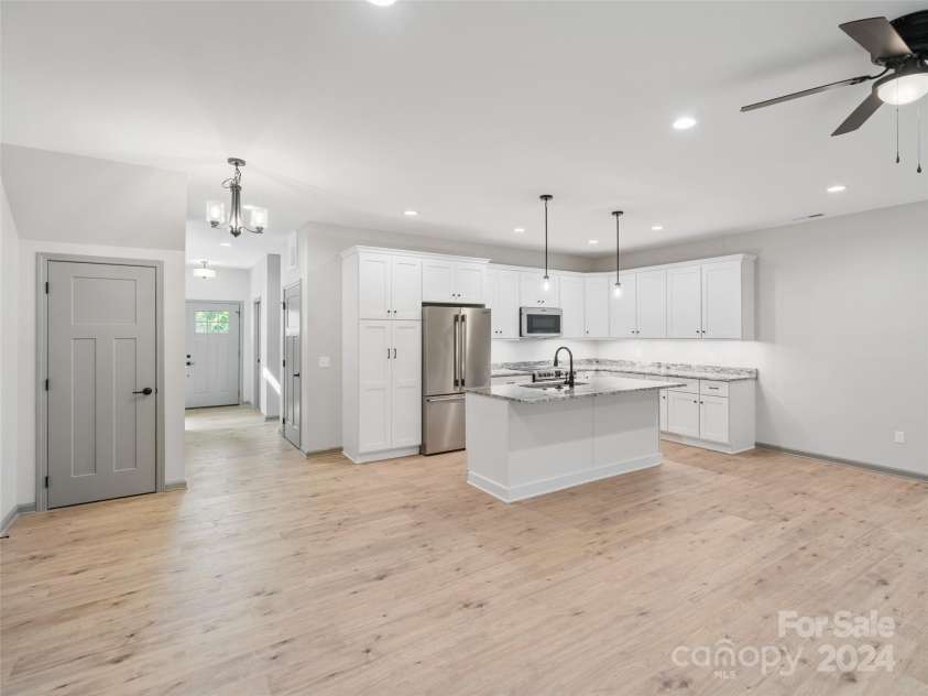 200 Red Twig Lane, Burnsville, NC 28714.  MLS# CAR4167529, YatesRealty ID 10723. Kichen also features counter height island with matching counter tops, farmsink within and microwave/air fryer