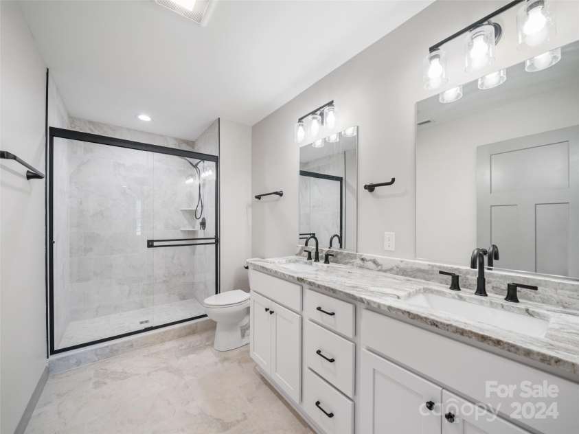 200 Red Twig Lane, Burnsville, NC 28714.  MLS# CAR4167529, YatesRealty ID 10723. Primary Bath on Upper level  with tiled floor and shower double vanity sinks, raised height toilets and beautiful tiled floor and shower