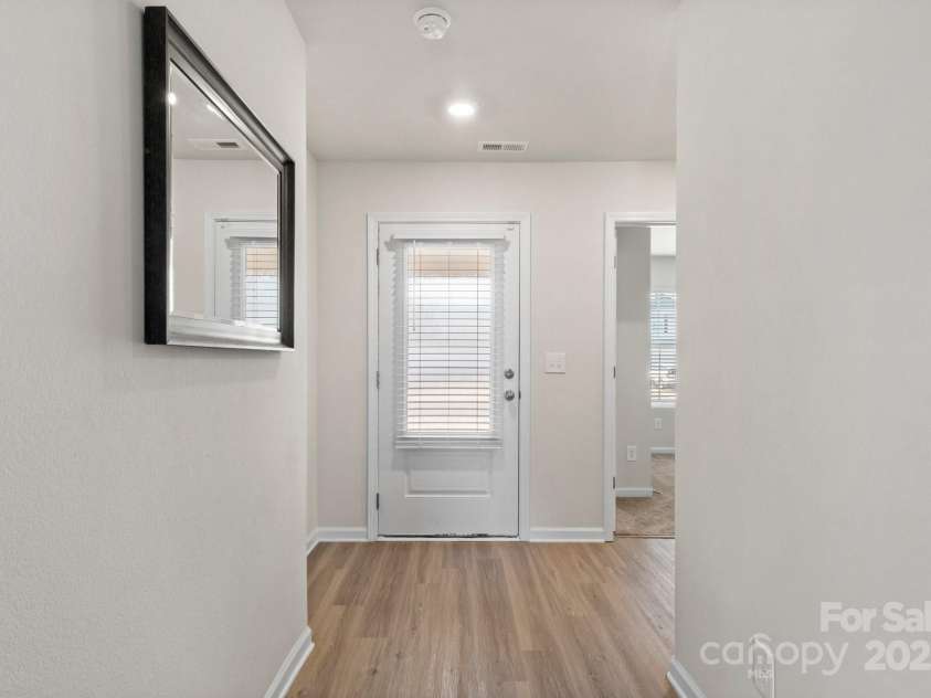 324 Aniston Lane, Shelby, NC 28152.  MLS# CAR4227228, YatesRealty ID 10727. View from the living area back to the front door + second and third bedrooms.