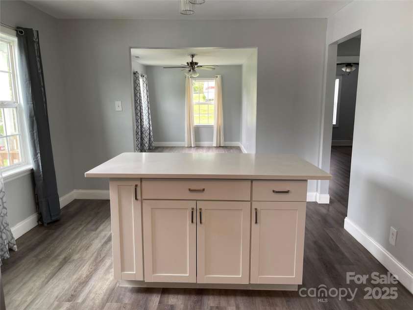106 Gibbs Street, Dallas, NC 28034.  MLS# CAR4298003, YatesRealty ID 10734. Island with storage - it is white and matches cabinets -( this view looks pinkish)