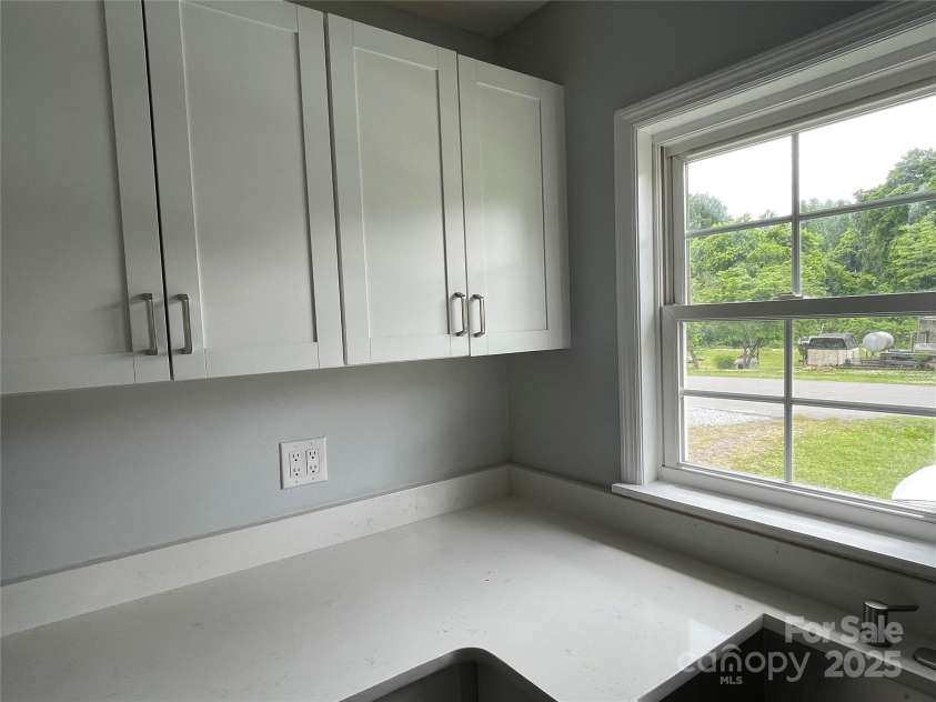 106 Gibbs Street, Dallas, NC 28034.  MLS# CAR4298003, YatesRealty ID 10734. Kitchen Cabinets with window view at sink