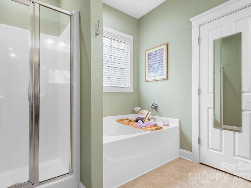 14541 Holly Springs Drive, Huntersville, NC 28078.  MLS# CAR4247448, YatesRealty ID 10760. Primary Bathroom walk-in shower, soaking tub, water closet w/ linen closet and storage area.