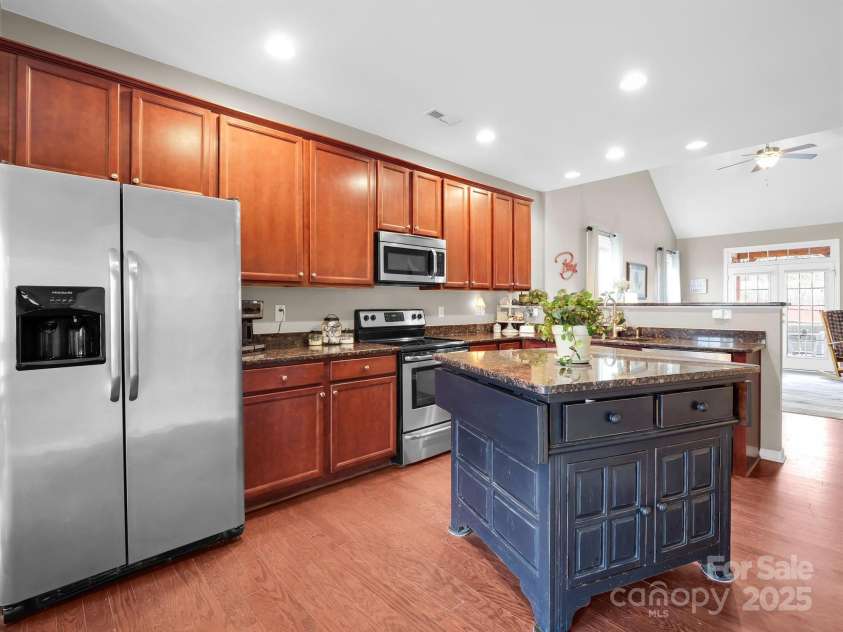 8 Mallard Run Drive, Arden, NC 28704.  MLS# CAR4238190, YatesRealty ID 10764. Open kitchen area provides views through the living room to the patio French doors.