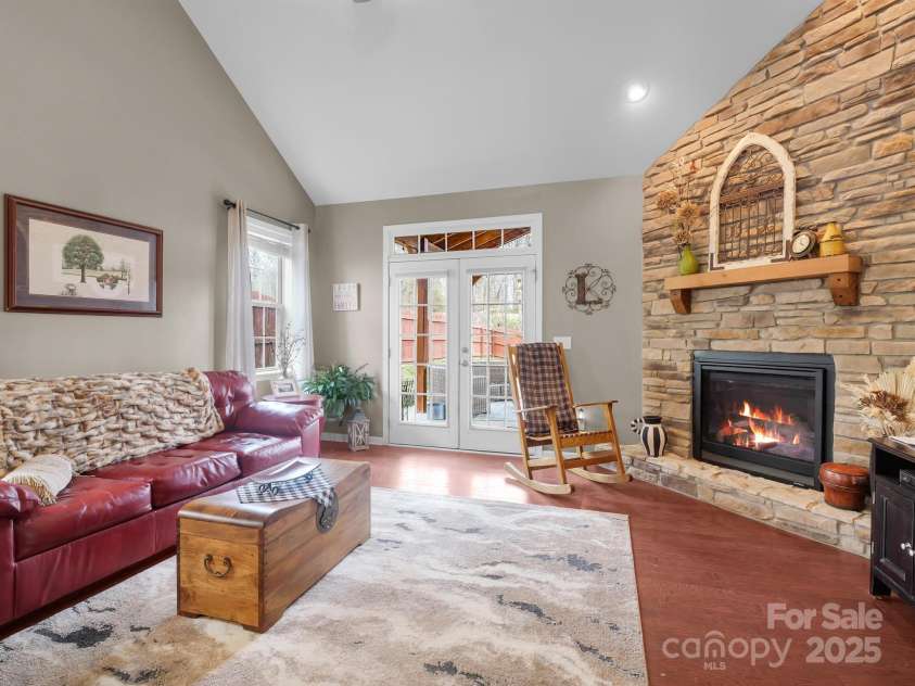 8 Mallard Run Drive, Arden, NC 28704.  MLS# CAR4238190, YatesRealty ID 10764. The living room has plenty of natural light from the back patio.