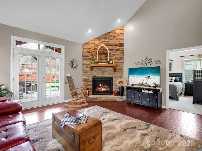 8 Mallard Run Drive, Arden, NC 28704.  MLS# CAR4238190, YatesRealty ID 10764. The natural gas fireplace is framed by a custom stone wall.