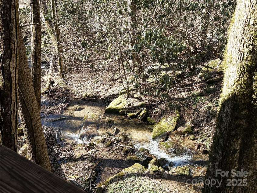 1080 Wolf Branch Road, Marshall, NC 28753.  MLS# CAR4233203, YatesRealty ID 10767. Creek in front of the house.