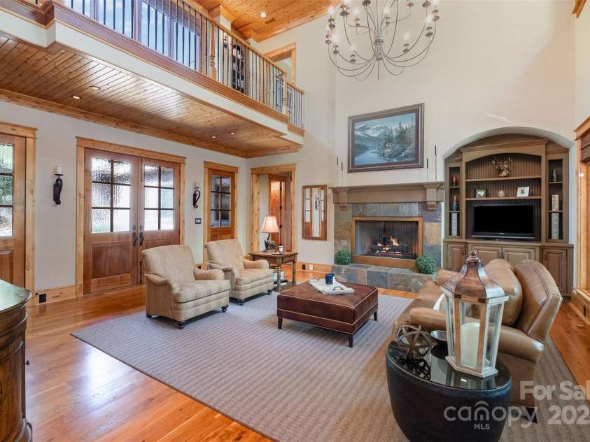 751 Mendenhall Court, Fort Mill, SC 29715.  MLS# CAR4239100, YatesRealty ID 10770. Great Room with entrance to Primary suite and 1 of 2 staircases upstairs