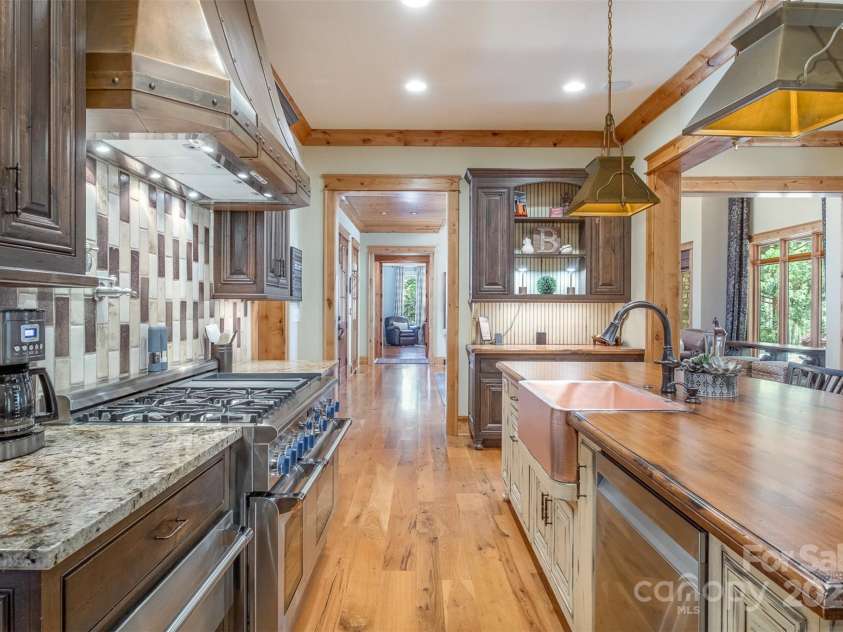 751 Mendenhall Court, Fort Mill, SC 29715.  MLS# CAR4239100, YatesRealty ID 10770. Shiny copper apron sink, custom island and backsplash