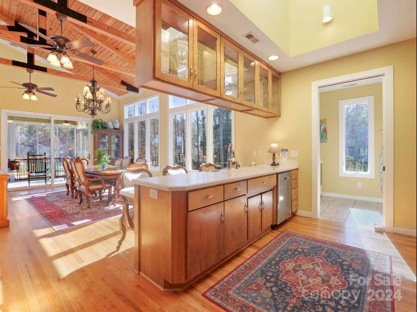 78 Assembly Drive, Flat Rock, NC 28731.  MLS# CAR4084810, YatesRealty ID 10772. View to the open kitchen and dining area.  The doorway leads to the main lever W/D and utility.