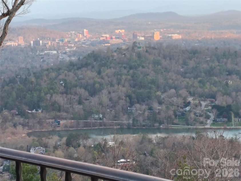 633 Altamont View, Asheville, NC 28804.  MLS# CAR4365453, YatesRealty ID 10781. Downtown shimmering in the setting sun