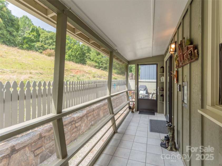 21 Flint Lane, Maggie Valley, NC 28751.  MLS# CAR4181508, YatesRealty ID 10824. Main Level Screened in Back Porch with Pasture Views