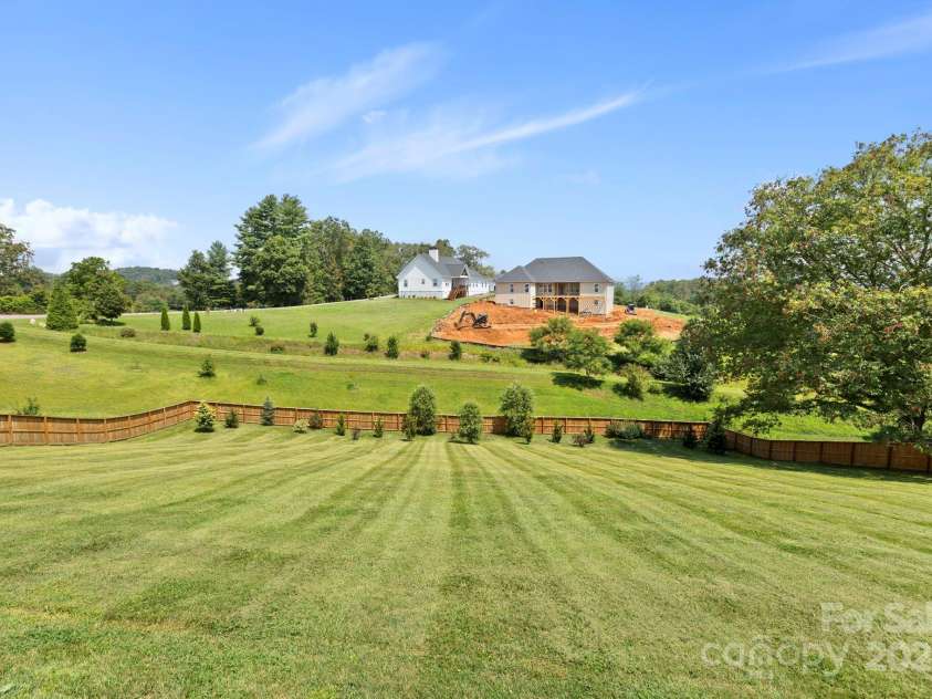 16 Enchanted Oak Lane, Alexander, NC 28701.  MLS# CAR4285091, YatesRealty ID 10833. Expansive fenced yard w/mtn views