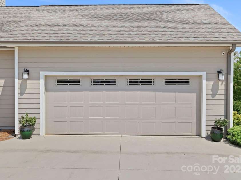16 Enchanted Oak Lane, Alexander, NC 28701.  MLS# CAR4285091, YatesRealty ID 10833. Garage w/cncrete driveway