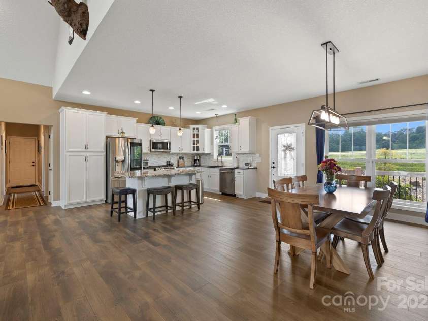 16 Enchanted Oak Lane, Alexander, NC 28701.  MLS# CAR4285091, YatesRealty ID 10833. Kitchen and dining area w/designer lighting
