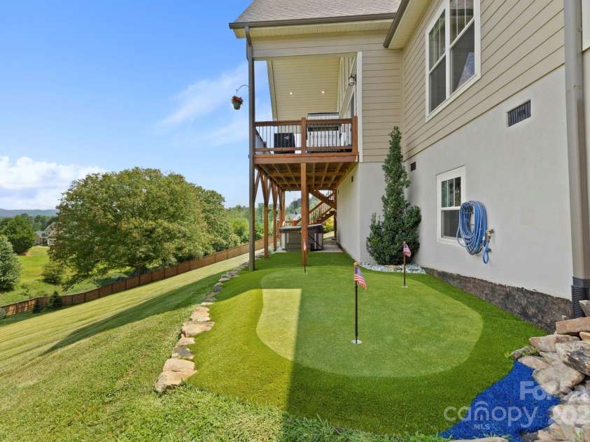 16 Enchanted Oak Lane, Alexander, NC 28701.  MLS# CAR4285091, YatesRealty ID 10833. Putting Green!