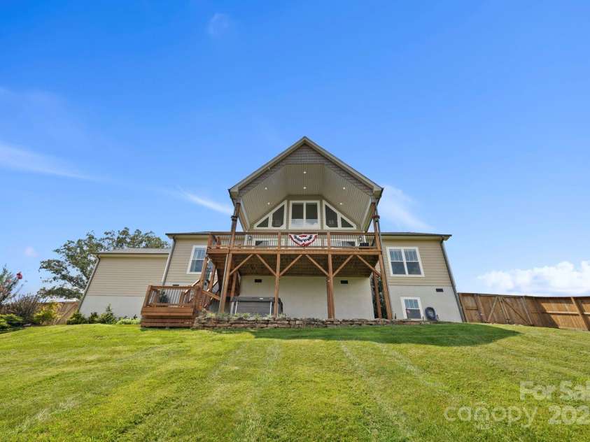 16 Enchanted Oak Lane, Alexander, NC 28701.  MLS# CAR4285091, YatesRealty ID 10833. Rear view of home w/expansive yard