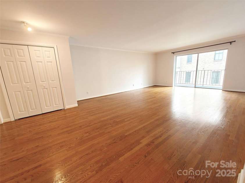 1323 Queens Road, Charlotte, NC 28207.  MLS# CAR4323169, YatesRealty ID 1088. Dining/Living Room looking towards Coat Closet & Balcony
