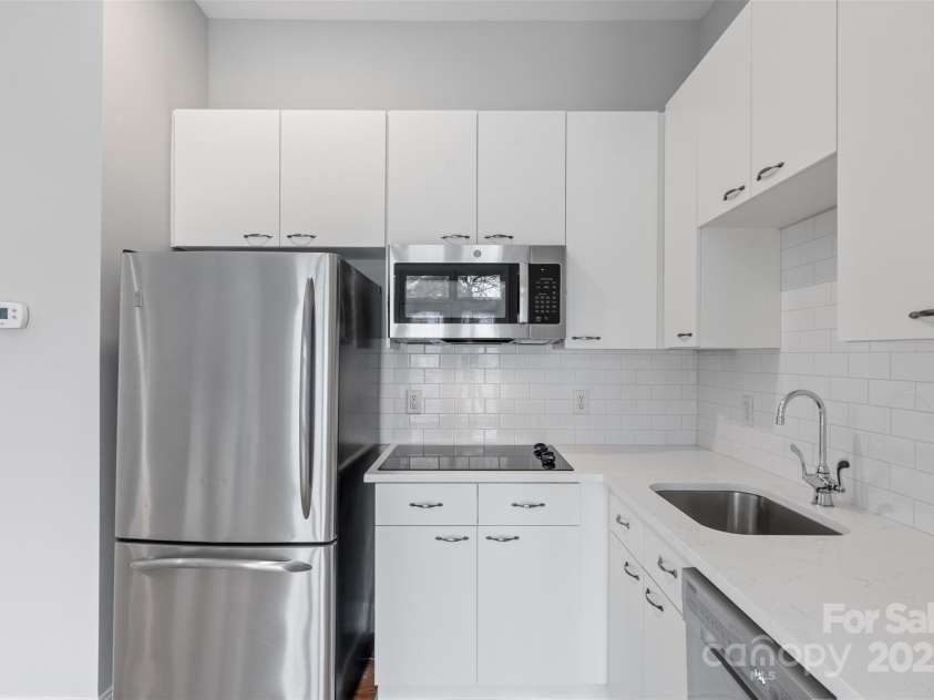 840 Garden District Drive, Charlotte, NC 28202.  MLS# CAR4238438, YatesRealty ID 10882. Bright White Kitchen with Solid Surface Countertops, New Appliances and Tiled Backsplash