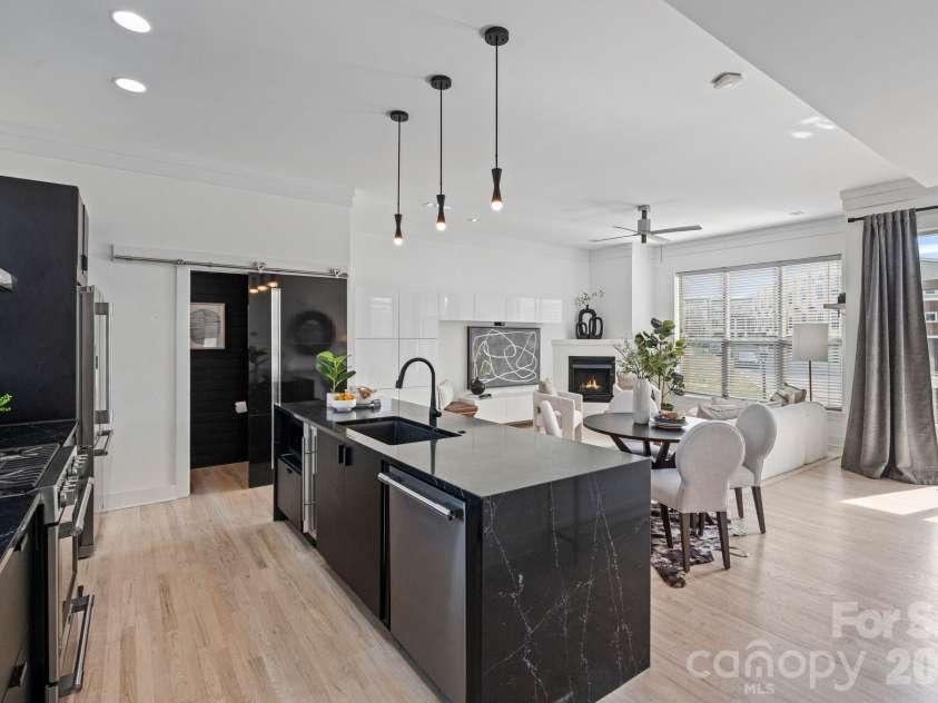 435 Steel Gardens Boulevard, Charlotte, NC 28205.  MLS# CAR4352693, YatesRealty ID 10901. Oversized waterfall black quartz kitchen island.