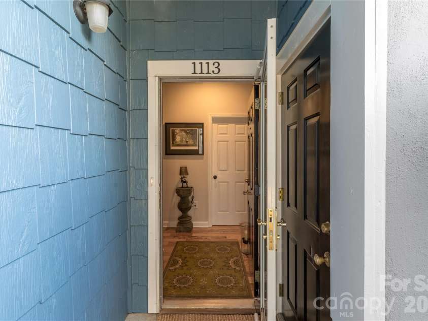 1113 Torrence Circle, Davidson, NC 28036.  MLS# CAR4337531, YatesRealty ID 10902. Entry with privacy wall.
