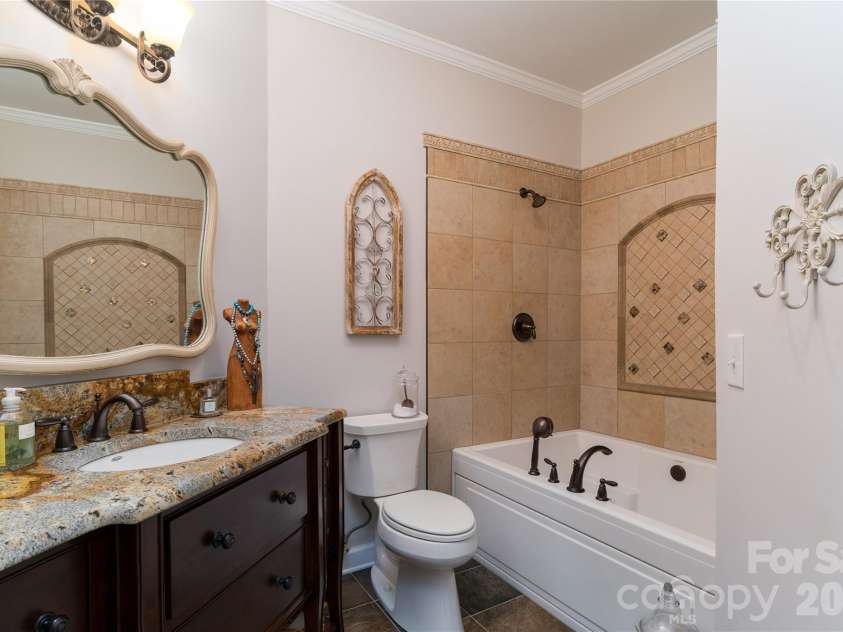 1113 Torrence Circle, Davidson, NC 28036.  MLS# CAR4337531, YatesRealty ID 10902. Primary bath has slate flooring and granite vanity.