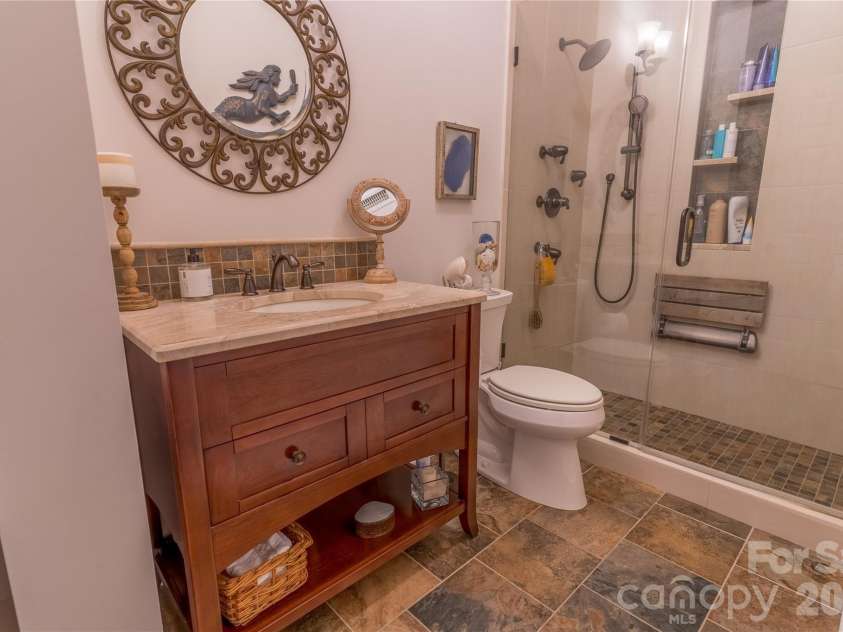 1113 Torrence Circle, Davidson, NC 28036.  MLS# CAR4337531, YatesRealty ID 10902. Slate tile and custom shower with seat in hall bath.