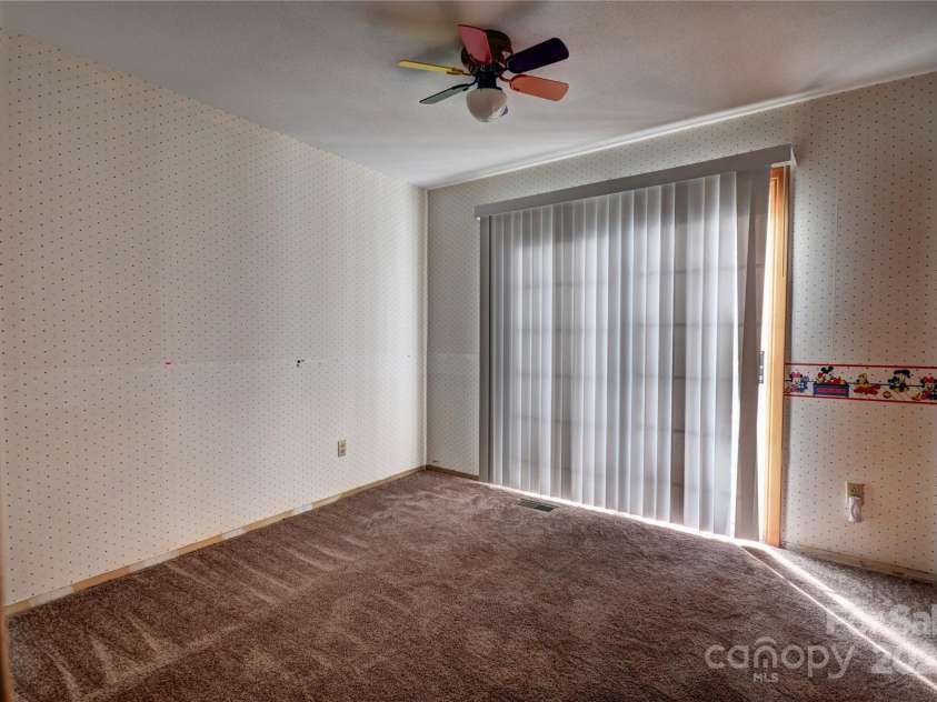 119 Pleasant Hill Circle, Waynesville, NC 28786.  MLS# CAR4325217, YatesRealty ID 1091. Bedroom 3 upper level with a sliding glass door to a small balcony