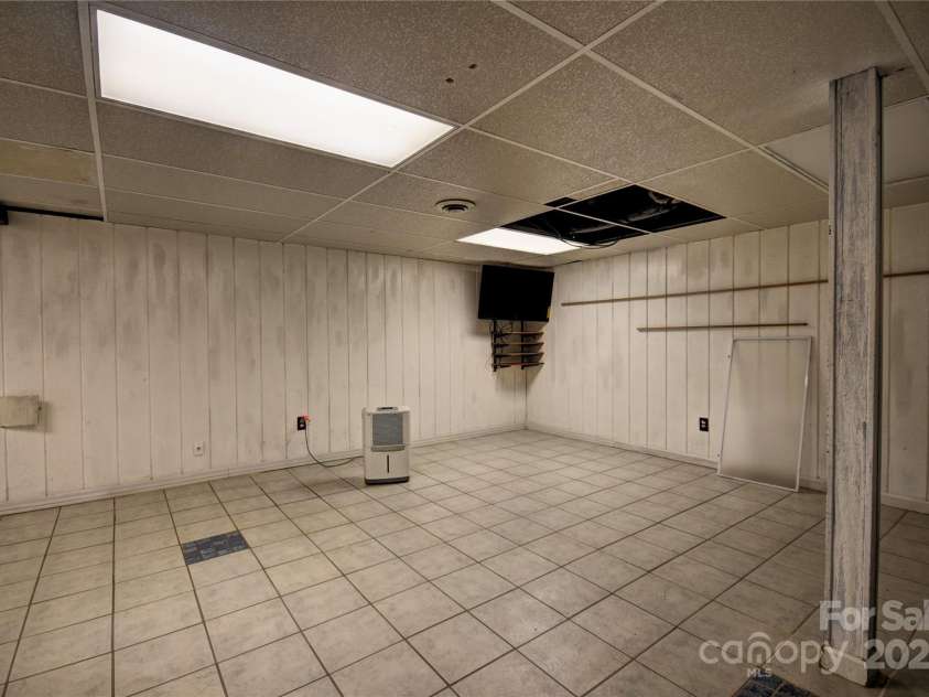 119 Pleasant Hill Circle, Waynesville, NC 28786.  MLS# CAR4325217, YatesRealty ID 1091. More of the rec room with exits outside to the concrete patio below the porch/deck