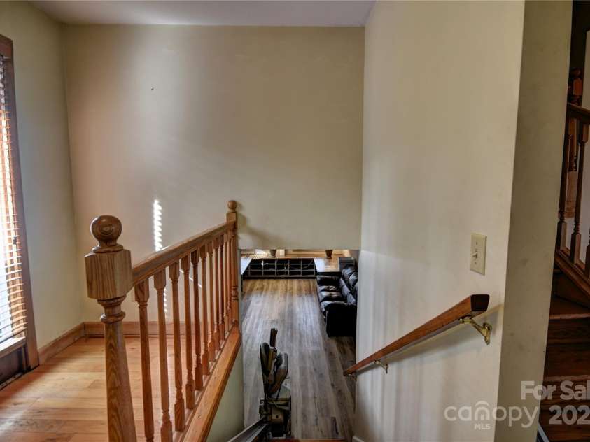 119 Pleasant Hill Circle, Waynesville, NC 28786.  MLS# CAR4325217, YatesRealty ID 1091. Stairs from the main level to the lower level- note the installed chair lift