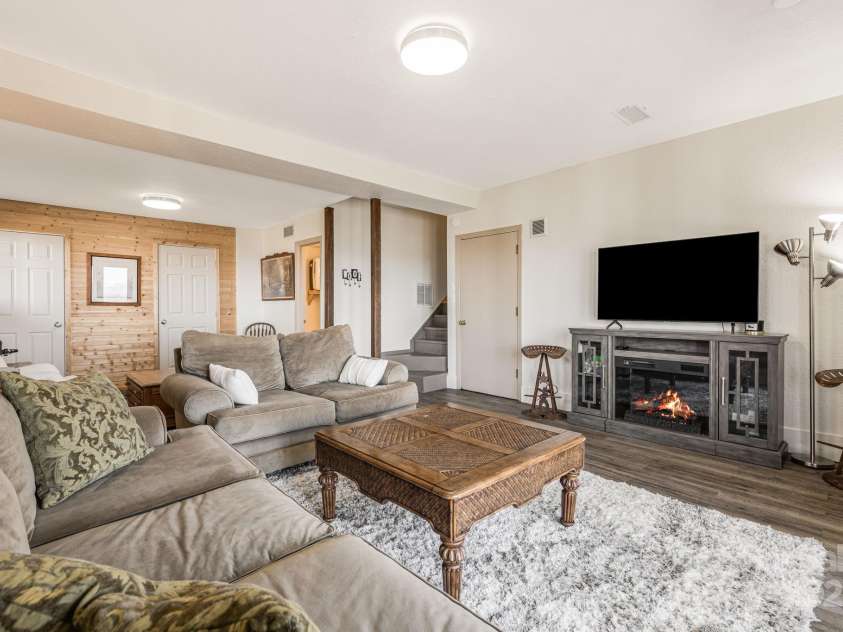 129 Finney Lane, Mars Hill, NC 28754.  MLS# CAR4243744, YatesRealty ID 10915. Lower level living room with 1/2 bath. Garage entrance, storage closets.