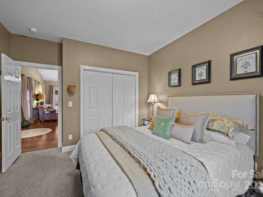 43 Smokemont Drive, Arden, NC 28704.  MLS# CAR4197497, YatesRealty ID 10921. Second main level secondary bedroom with neutral carpet.  Bed here is a queen size.
