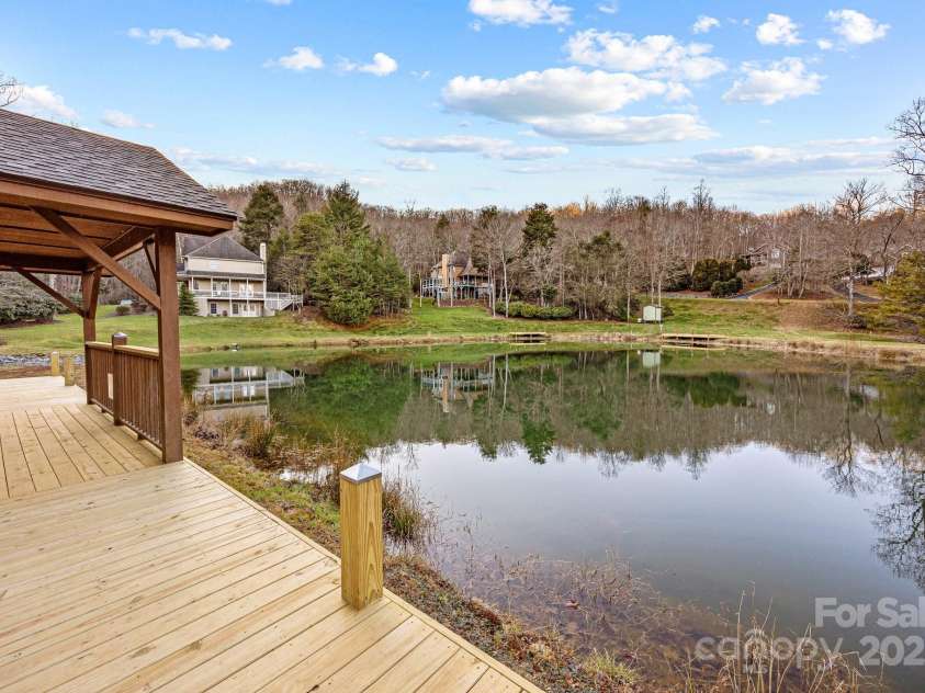 43 Smokemont Drive, Arden, NC 28704.  MLS# CAR4197497, YatesRealty ID 10921. View from the trout pond deck toward the house (the one in the upper center of the photo)