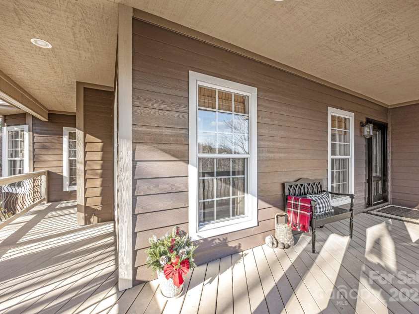43 Smokemont Drive, Arden, NC 28704.  MLS# CAR4197497, YatesRealty ID 10921. Wrap around front deck to sit and gaze upon the trout pond