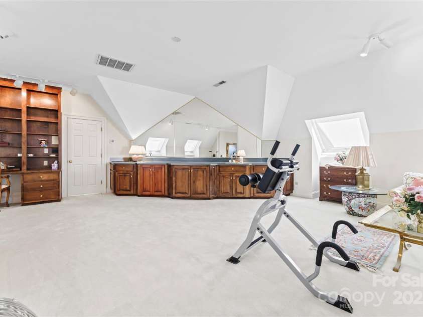 8934 Winged Bourne Drive, Charlotte, NC 28210.  MLS# CAR4245906, YatesRealty ID 10929. Second floor of primary suite with wet bar, built in desk/ office and SO MUCH SPACE.