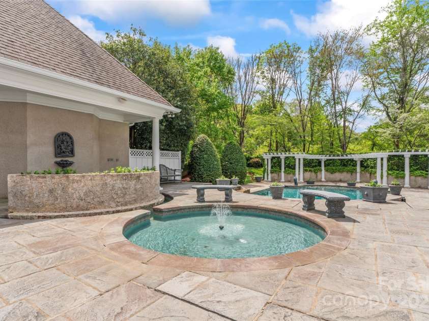 8934 Winged Bourne Drive, Charlotte, NC 28210.  MLS# CAR4245906, YatesRealty ID 10929. THREE pools for your enjoyment! This sprinkler dipper, the hot tub behind the private curved wall, and the large pool. There is a pool bath/ shower as well