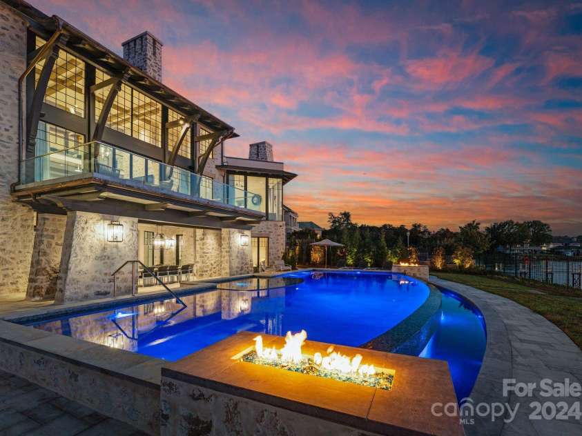 19125 Peninsula Point Drive, Cornelius, NC 28031.  MLS# CAR4180906, YatesRealty ID 1093. The pool exudes a luxurious, resort-worthy atmosphere, offering the ultimate retreat in your own backyard.
