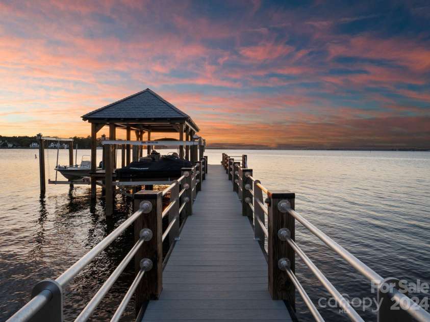 19125 Peninsula Point Drive, Cornelius, NC 28031.  MLS# CAR4180906, YatesRealty ID 1093. The private and fixed dock features two boat lifts as well as two jet ski lifts.
